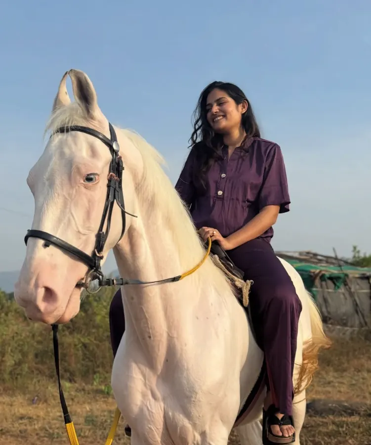 Guest horse riding through the grounds of Azure Resort near Pawna Lake